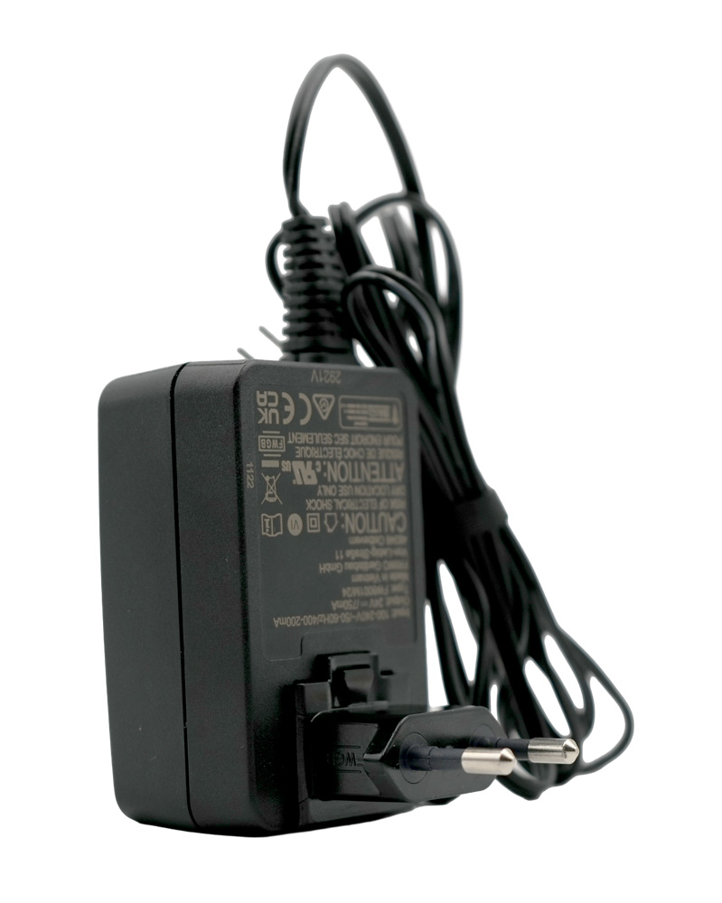 Plug-in power supply for Testomat LIMIT, our item number 30996, standing on the right-hand side with cable in the background